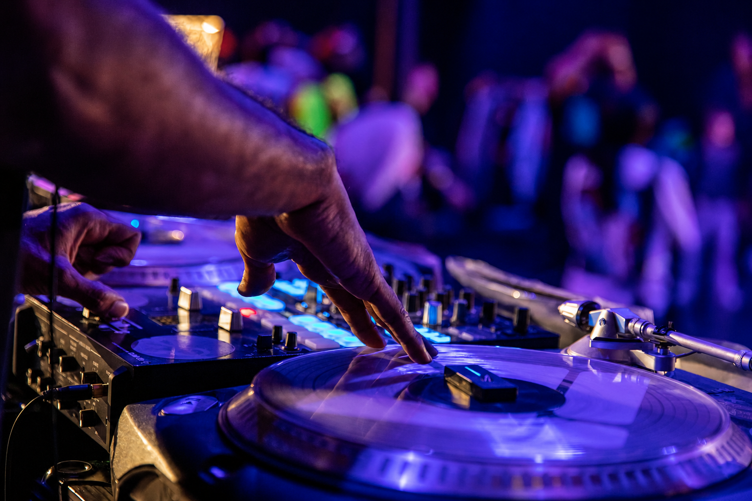 A DJ scratching a vinyl record during a private event