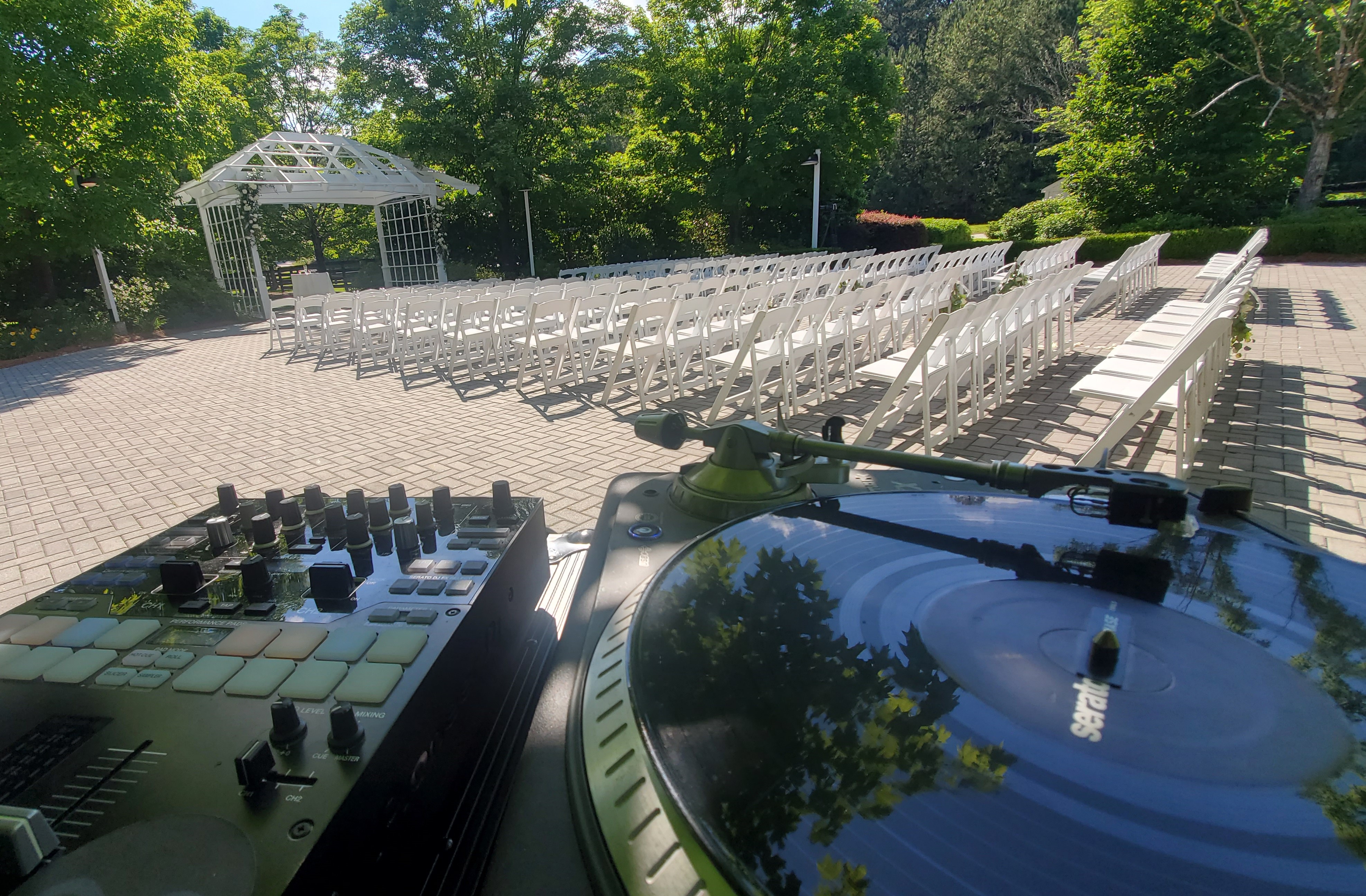 DJ turntables set for an outdoor wedding ceremony